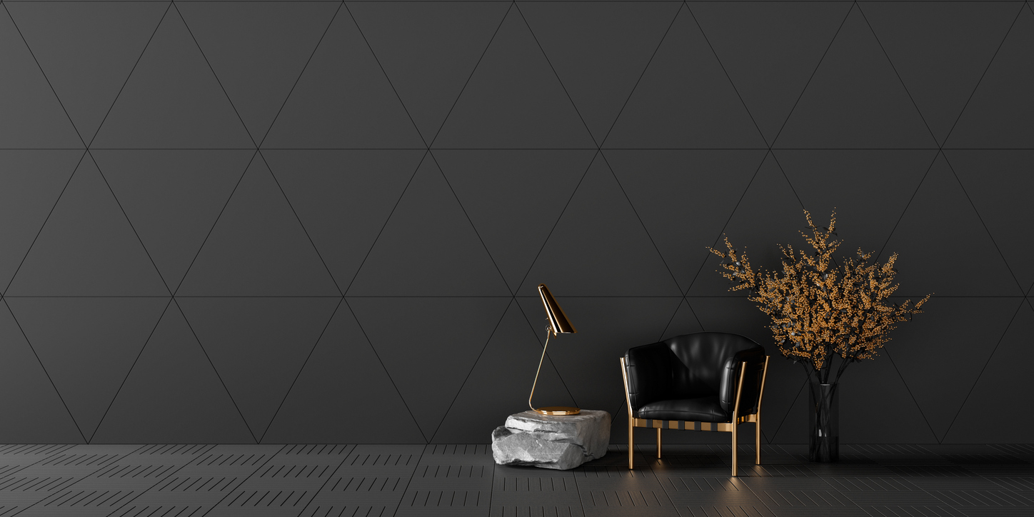 Contemporary interior with a black armchair and dark geometric feature wall